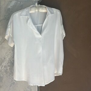 Sim and Sam short sleeve women's blouse with button details in back.